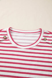 Textured knit tee with red stripes, crew neck, and decorative button detail.
