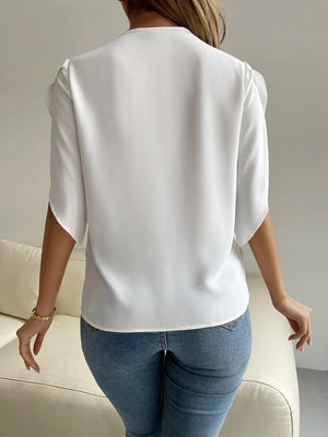 White polyester blouse with cape sleeves and lace trim detail.