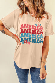 Tan graphic tee with stacked "America" text and floral accents.