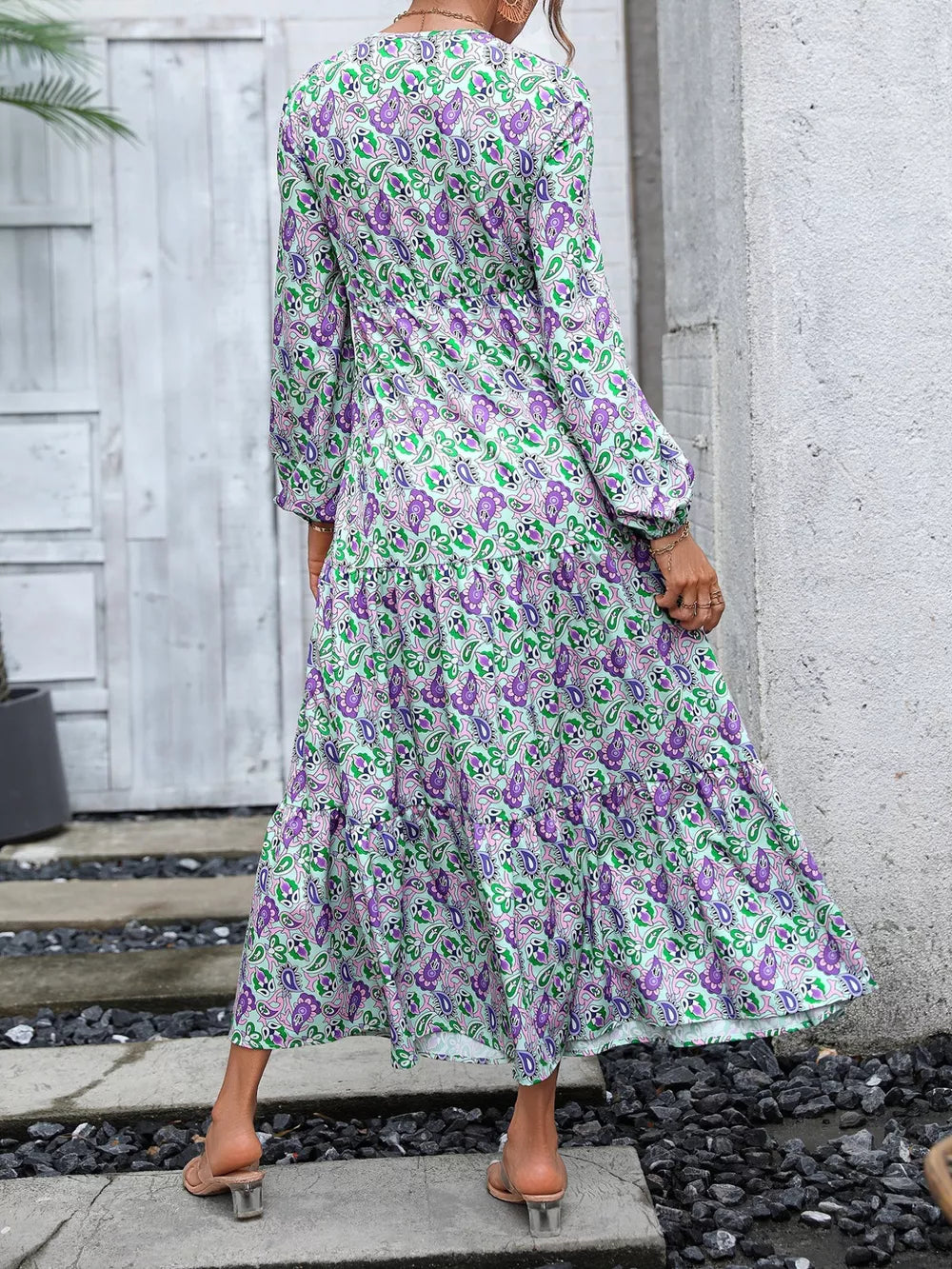 Vibrant paisley print maxi dress with balloon sleeves and tiered skirt.