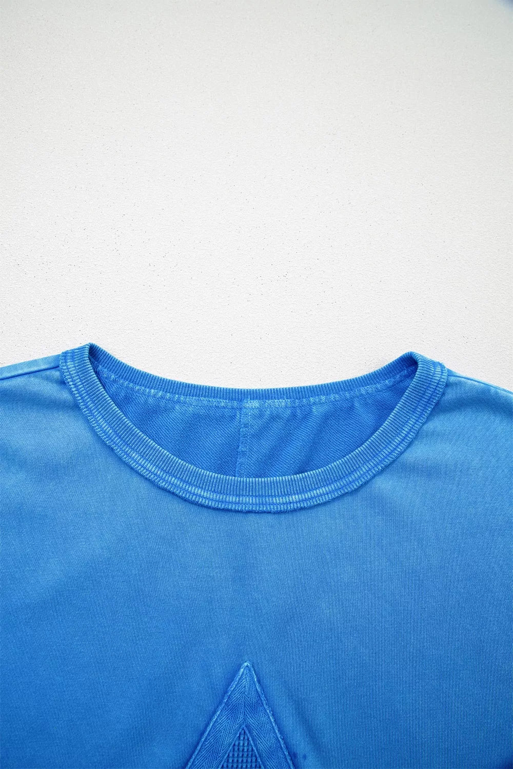 Blue mineral wash cotton tee with triangle patch detail and crew neck.