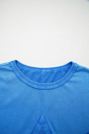 Blue mineral wash cotton tee with triangle patch detail and crew neck.
