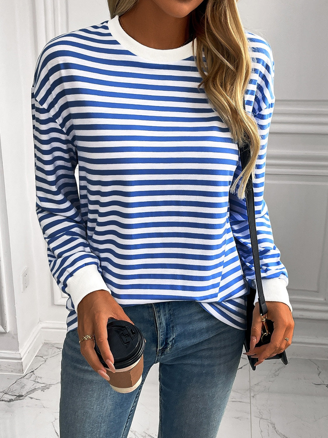 Horizontal stripe crewneck sweatshirt with cuffs in royal blue and white, featuring long sleeves and ribbed cuffs.