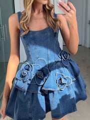 Denim mini dress with floral appliques, ruffled tiers, and a corset bodice.