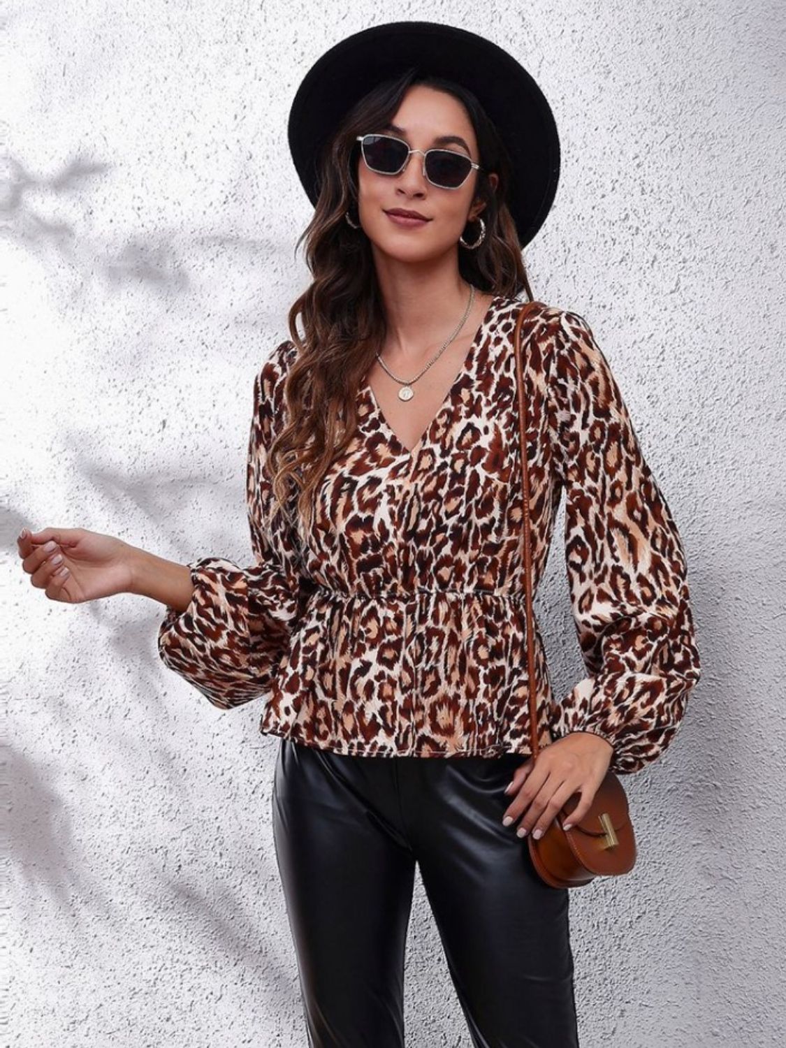 Leopard peplum blouse with gathered waist, V-neck, and balloon sleeves.