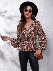 Leopard peplum blouse with gathered waist, V-neck, and balloon sleeves.