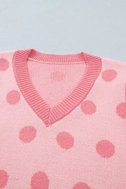 Pink polka dot knit cardigan with V-neck and ribbed trim.
