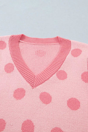 Pink polka dot knit cardigan with V-neck and ribbed trim.