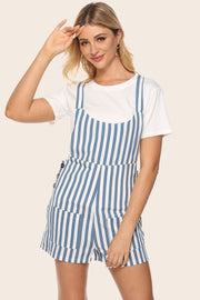 Button-detail striped pinafore romper with pockets, styled over a white tee.