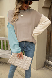 Colorblock knit pullover sweater with pastel blue and khaki sleeves.