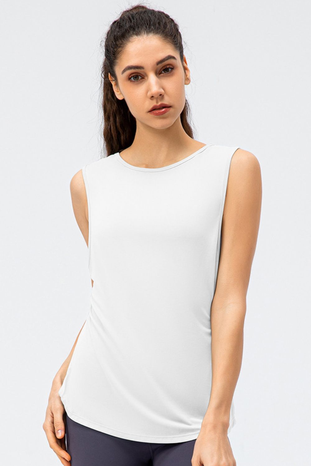 White performance tank top with a rounded neckline and strappy back detail.