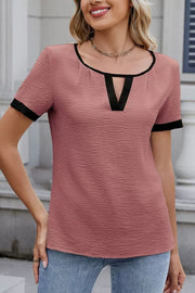 Dusty pink textured blouse with black contrast trim and keyhole neckline