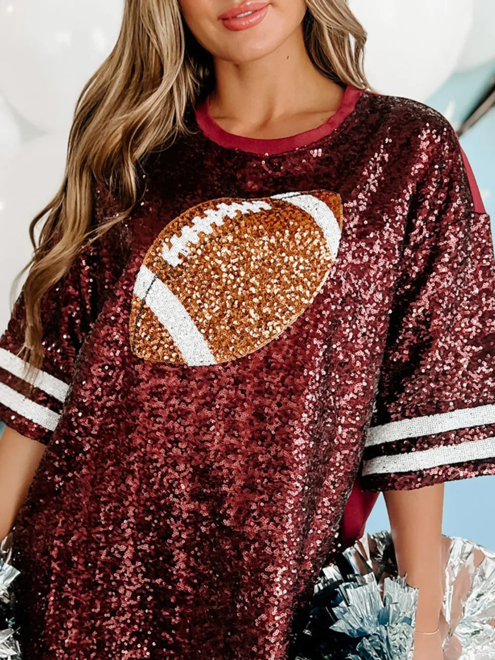 Burgundy sequin oversized tee dress with football graphic and striped sleeves.