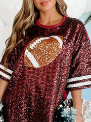Burgundy sequin oversized tee dress with football graphic and striped sleeves.