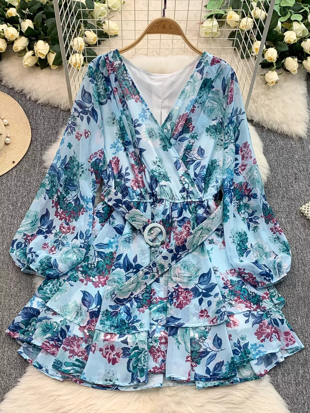 Light blue floral print wrap mini dress with ruffled hem and belt