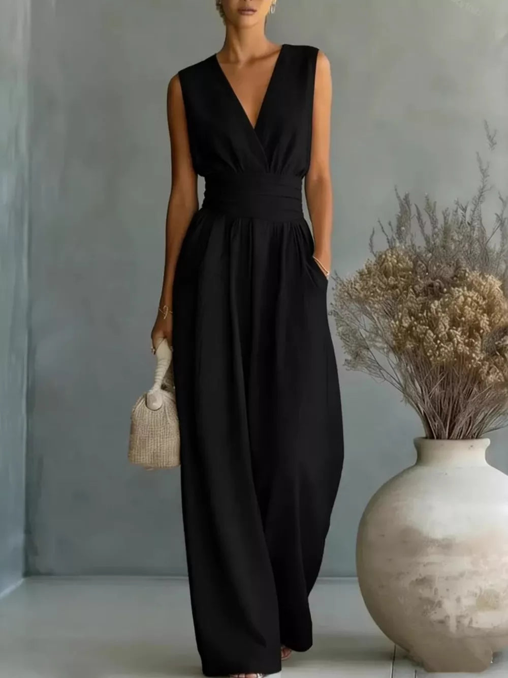 Black sleeveless wide-leg jumpsuit with cinched waist and pockets