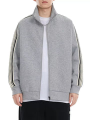Plus-size grey zip-up sweatshirt with contrast stripe detail on sleeves and mock neck.