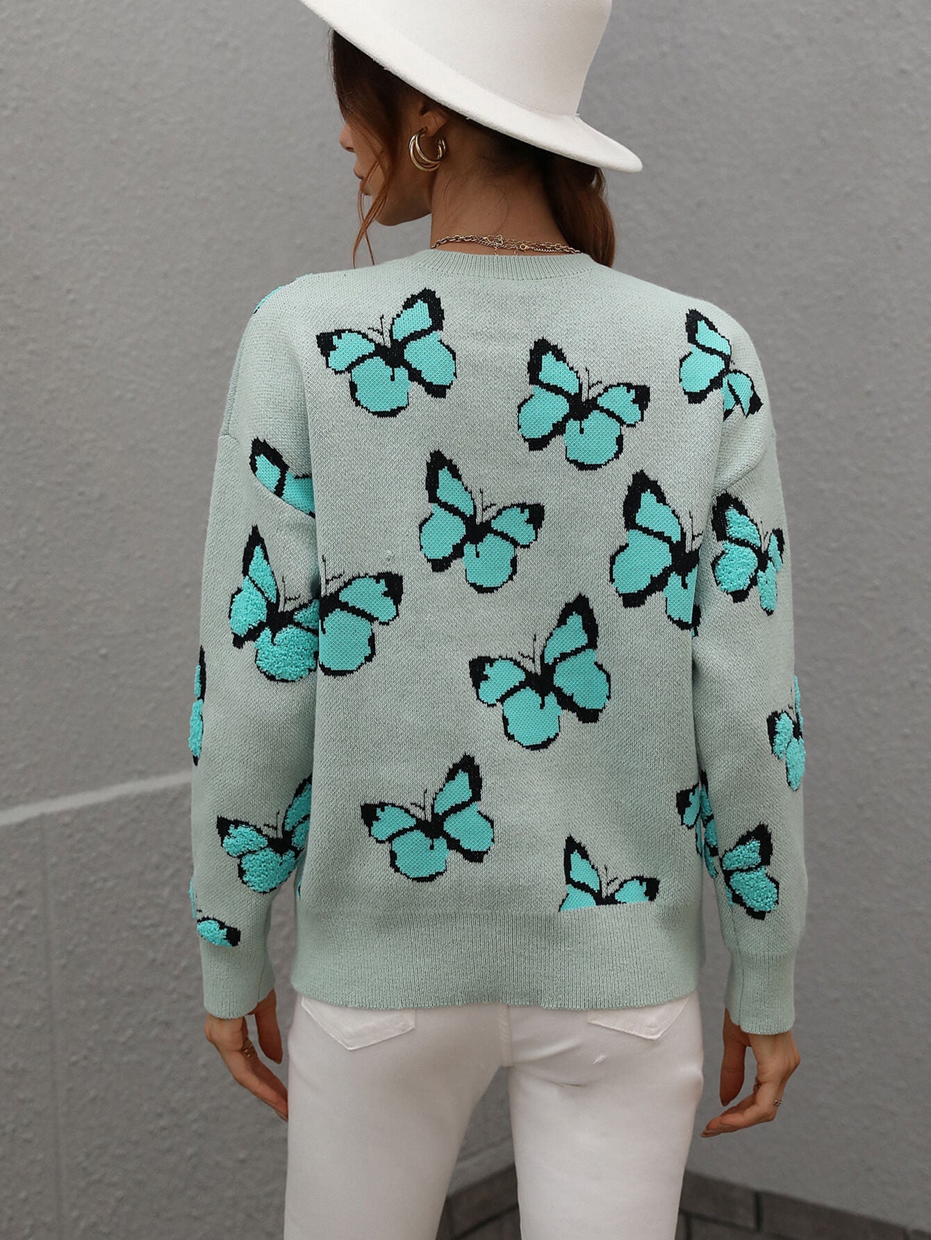 Sky blue knit crewneck sweater with allover butterfly motif.