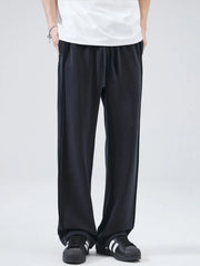 Black relaxed fit drawstring casual pants with side seam detail.