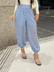 Blue polka dot maternity pants with high waist and cinched ankles.