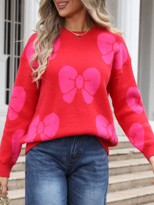 Red acrylic sweater with allover pink bow pattern and crew neck.