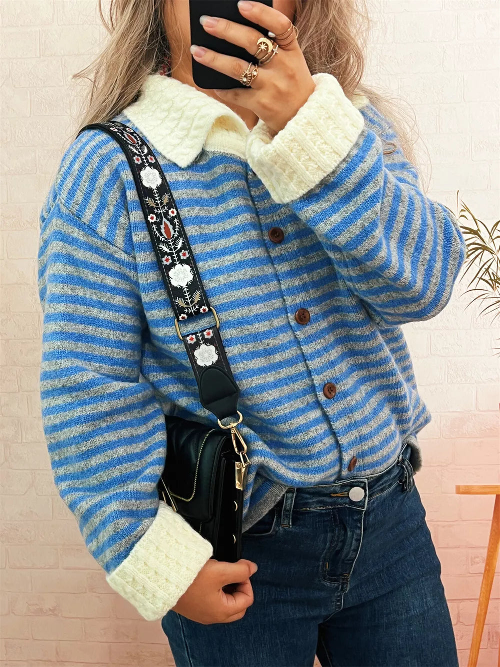 Blue striped knit cardigan with textured collar and cuffs, button-down front.