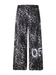 Leopard print cotton sweatpants with drawstring waist and wide legs, featuring a "05" graphic detail.