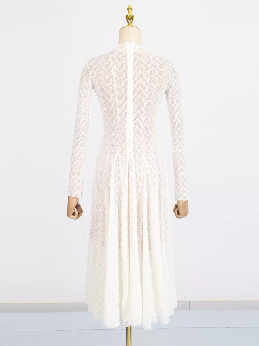 White lace maxi dress with mock neck, long sleeves, and a full skirt.