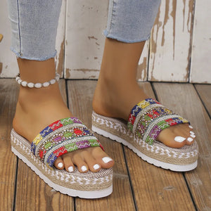 Multicolor embroidered espadrille platform slides with woven jute detail.