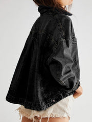 Oversized washed black denim trucker jacket with button details and a relaxed fit.