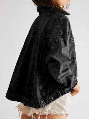 Oversized washed black denim trucker jacket with button details and a relaxed fit.