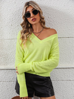 Relaxed fit v-neck knit sweater in yellow-green with long sleeves and ribbed cuffs.
