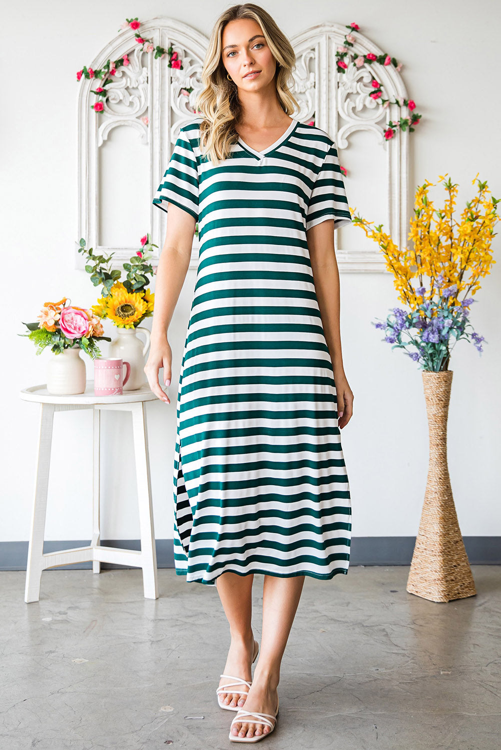 Green and white striped jersey maxi dress with short sleeves and a slit hem.