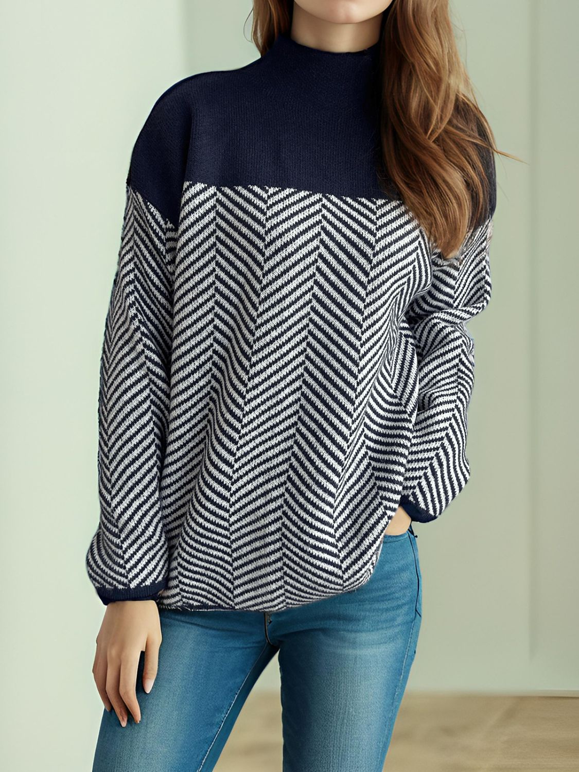 Chevron knit turtleneck sweater in dark blue and white with a colorblock design.