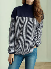 Chevron knit turtleneck sweater in dark blue and white with a colorblock design.