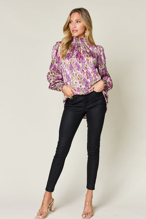 High neck abstract print blouse in red-violet with long sleeves and a satin finish.