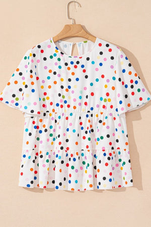 White tiered blouse with rainbow polka dots and flutter sleeves.