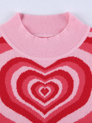 Pink knit tank top with concentric heart intarsia pattern in shades of red and pink.