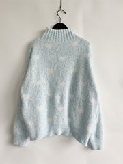 Mint blue acrylic turtleneck sweater with allover white heart motif and textured knit.
