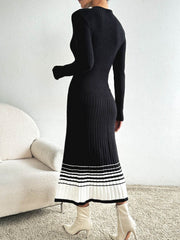 Black ribbed knit midi dress with contrast striped hem and long sleeves.