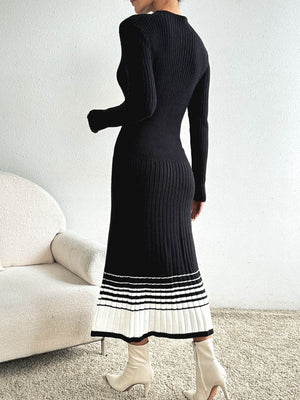 Black ribbed knit midi dress with contrast striped hem and long sleeves.