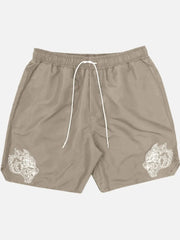 Khaki performance shorts with white embroidered wolf heads on both legs.