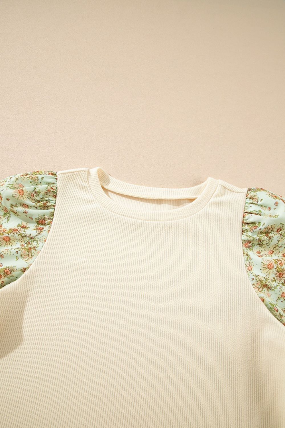 Beige ribbed knit top with floral puff sleeves