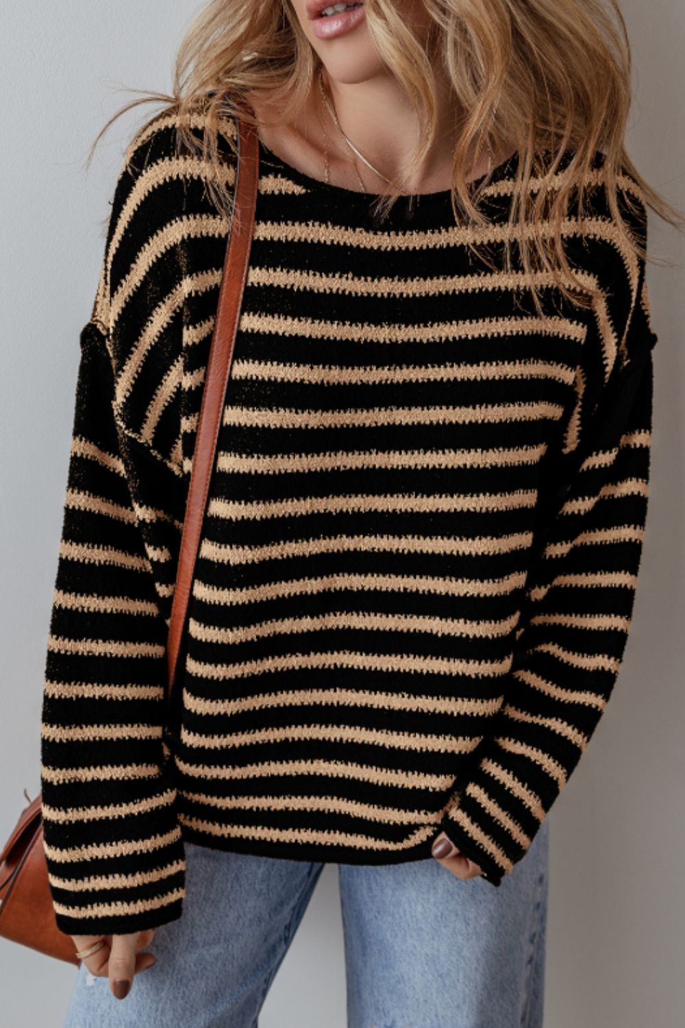 Black and tan horizontal stripe slouchy knit jumper with a crew neck.