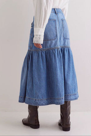 Denim midi skirt in medium wash with flounce hem and pockets.
