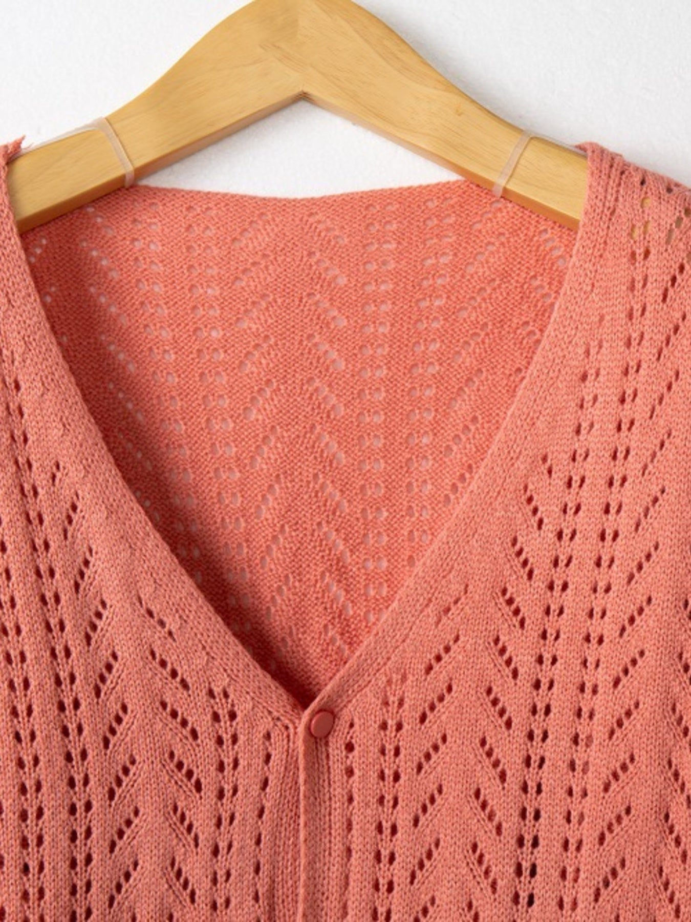 Chevron knit cardigan in burnt coral with a V-neck and button front.