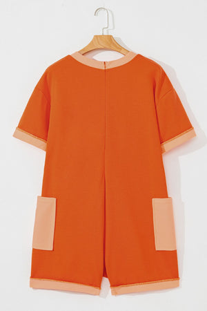 Orange colorblock romper with patch pockets and contrast trim.