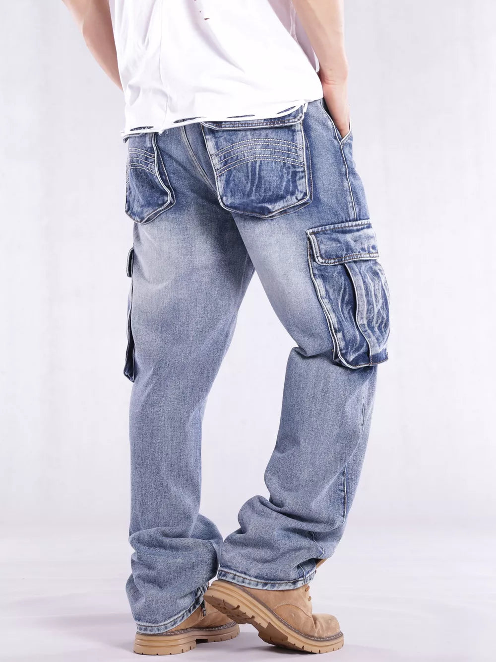 Relaxed fit light wash denim cargo jeans with flap pockets and contrast stitching.