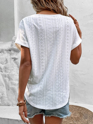 White eyelet v-neck tunic top with short sleeves and a relaxed fit.