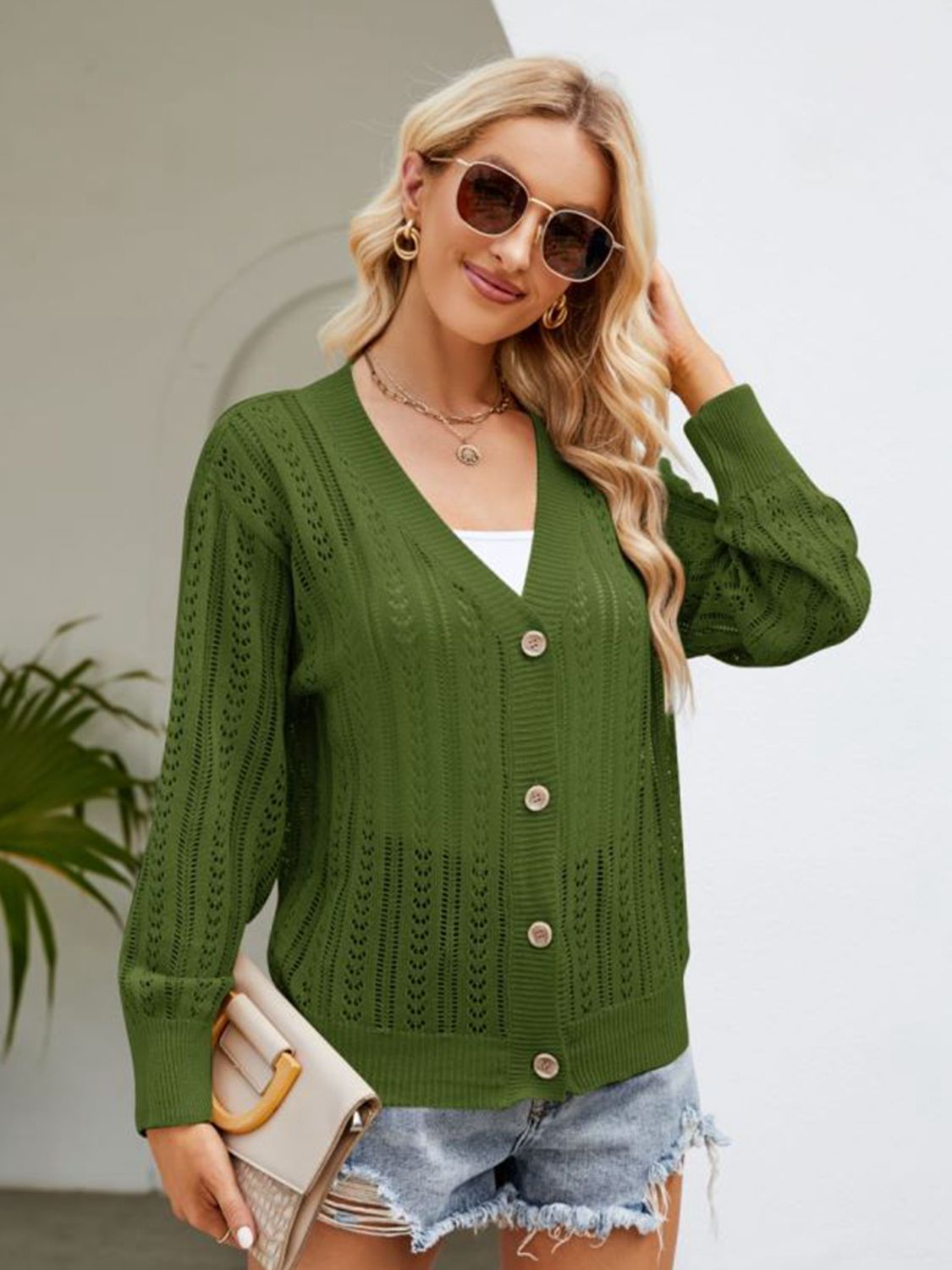 Army green ribbed trim cardigan with button front and open knit detail.